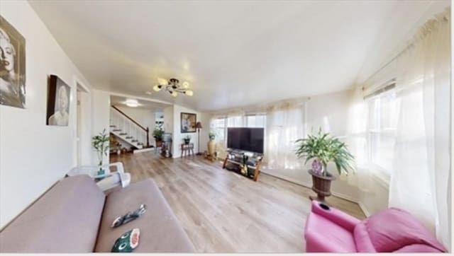 95 Prospect Street Ext, Westfield, MA 01085 - living room featuring plenty of natural light, stairway, wood finished floors, and a chandelier