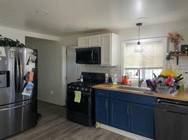 95 Prospect Street Ext, Westfield, MA 01085 - kitchen with black appliances, blue cabinetry, tasteful backsplash, white cabinets, and wood finished floors