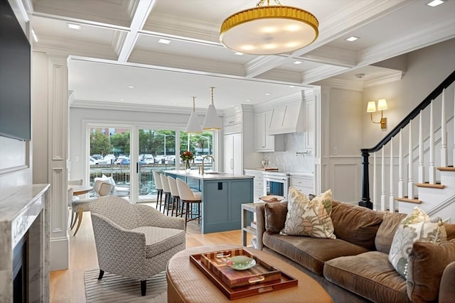 8 Union Wharf Unit 8, Boston, MA 02109 - living room with coffered ceiling, crown molding, beamed ceiling, stairway, and light wood-style floors