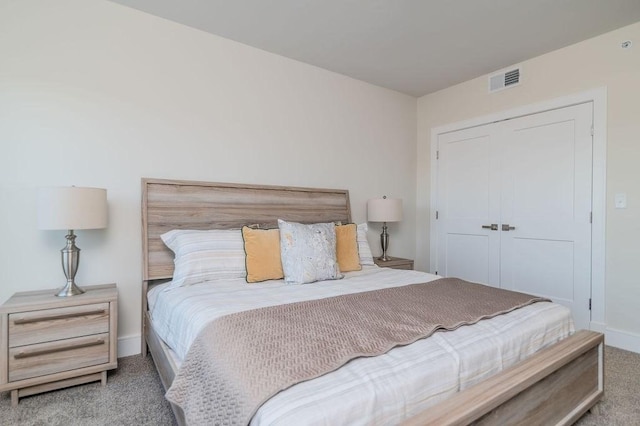 bedroom with light colored carpet and a closet