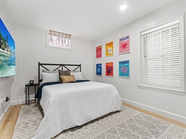 bedroom featuring light wood finished floors, recessed lighting, and baseboards