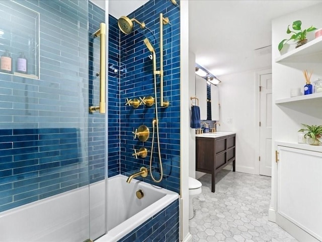 full bath featuring tile patterned flooring, tiled shower / bath combo, vanity, and toilet