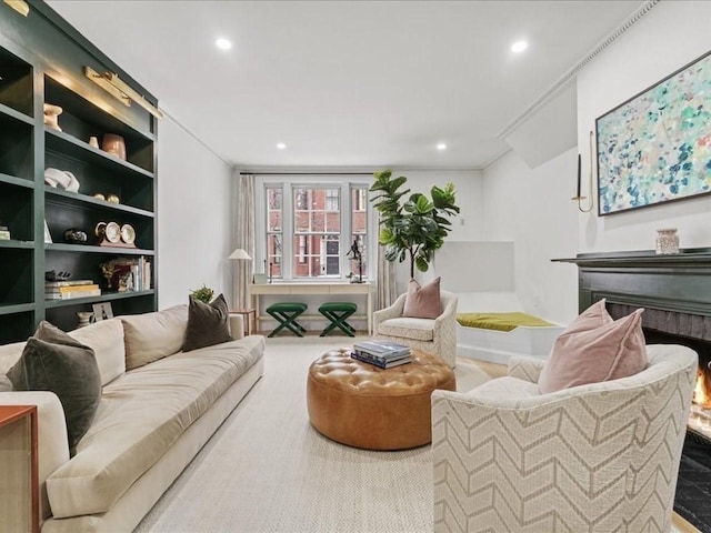 living area featuring built in shelves and recessed lighting