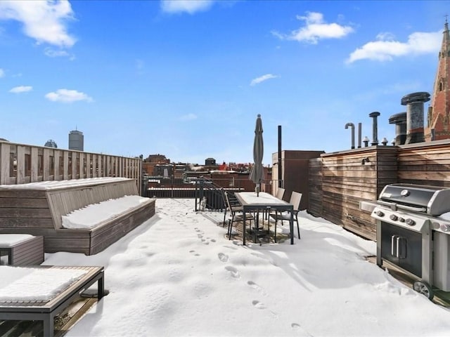 snow covered patio with outdoor dining area