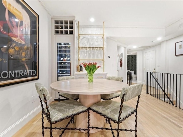 dining space featuring baseboards and light wood finished floors