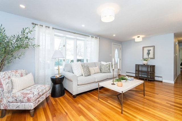 living room with light hardwood / wood-style flooring and a baseboard radiator