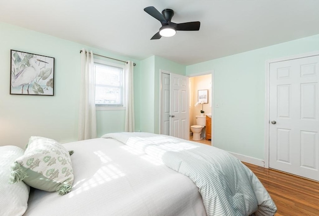 bedroom with ensuite bath, wood-type flooring, and ceiling fan