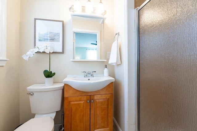 bathroom with vanity, toilet, and an enclosed shower