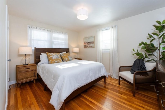 bedroom with dark wood-type flooring