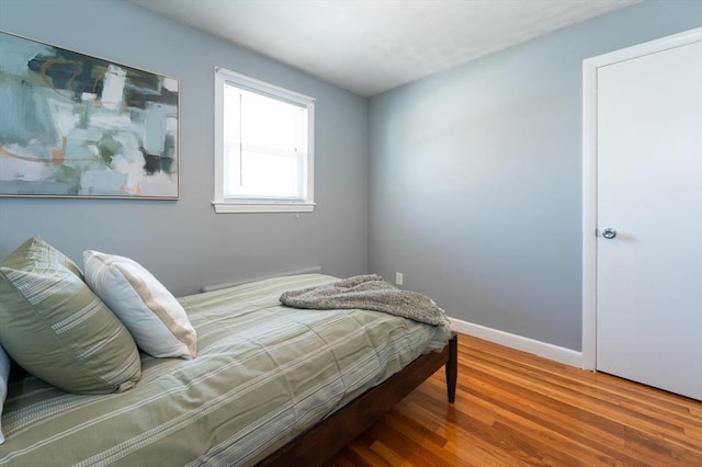 bedroom with hardwood / wood-style flooring