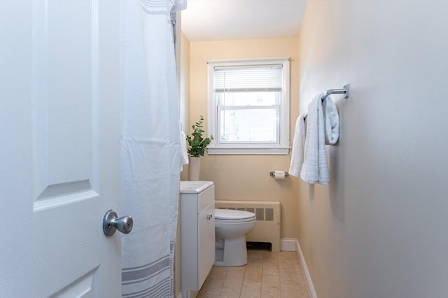 bathroom featuring vanity, radiator, and toilet