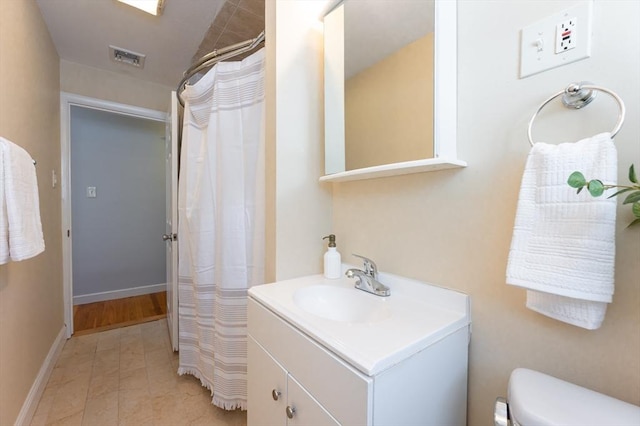 bathroom featuring vanity and toilet