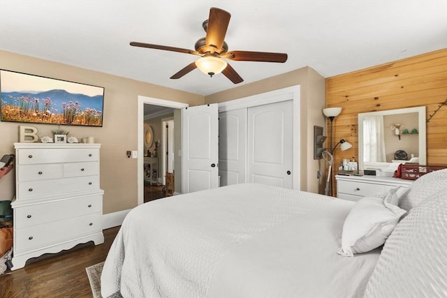 53 Avon St, Taunton, MA 02780 - bedroom featuring dark wood-style floors, wood walls, a closet, ceiling fan, and baseboards