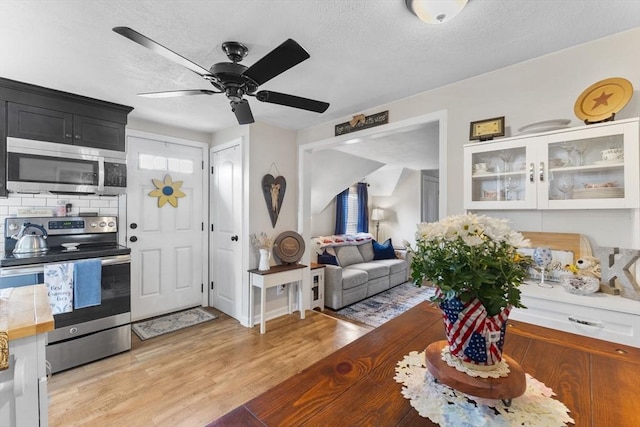 53 Avon St, Taunton, MA 02780 - living room featuring light wood-type flooring, ceiling fan, and a textured ceiling