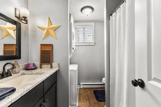53 Avon St, Taunton, MA 02780 - bathroom with a baseboard radiator, vanity, wood finished floors, and toilet