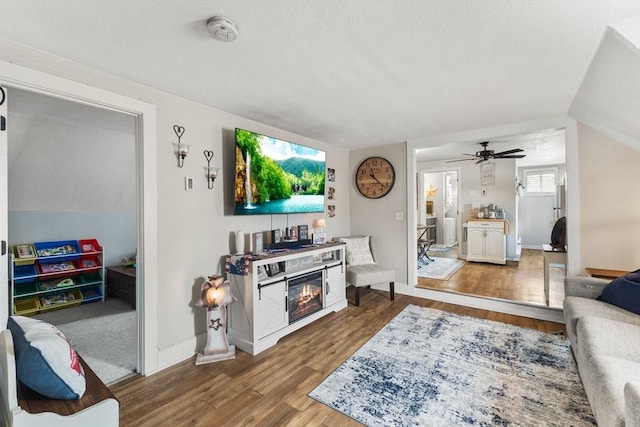 53 Avon St, Taunton, MA 02780 - living area with wood finished floors, ceiling fan, a glass covered fireplace, and baseboards