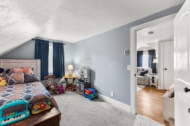 53 Avon St, Taunton, MA 02780 - carpeted bedroom with a textured ceiling, vaulted ceiling, and baseboards