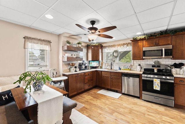 53 Avon St, Taunton, MA 02780 - kitchen with appliances with stainless steel finishes, a sink, open shelves, light wood-style flooring, and ceiling fan