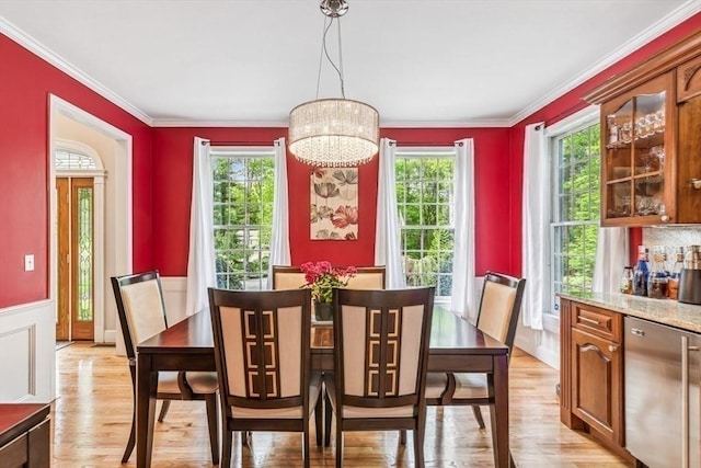 225 Walker St, Seekonk, MA 02771 - dining room featuring light wood-style flooring, crown molding, a chandelier, and a wainscoted wall