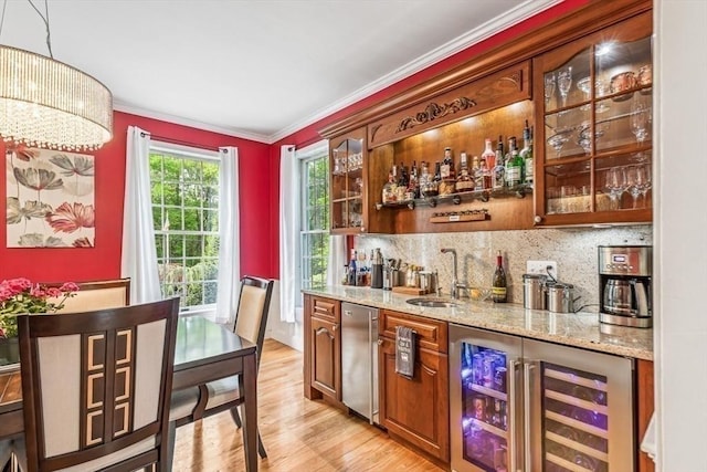 225 Walker St, Seekonk, MA 02771 - indoor wet bar with wine cooler, ornamental molding, light wood-style flooring, decorative backsplash, and fridge