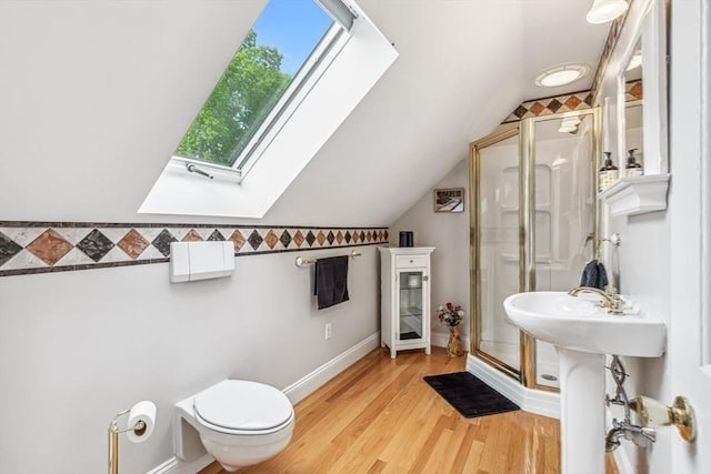 225 Walker St, Seekonk, MA 02771 - full bathroom featuring a shower stall, vaulted ceiling, a skylight, wood finished floors, and baseboards
