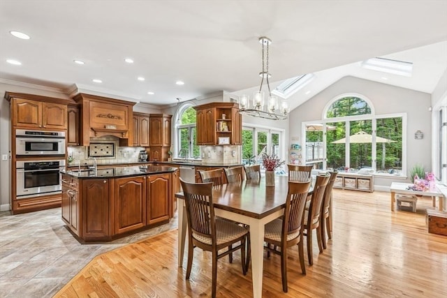 225 Walker St, Seekonk, MA 02771 - dining area with a chandelier, plenty of natural light, light wood-style floors, lofted ceiling, and recessed lighting