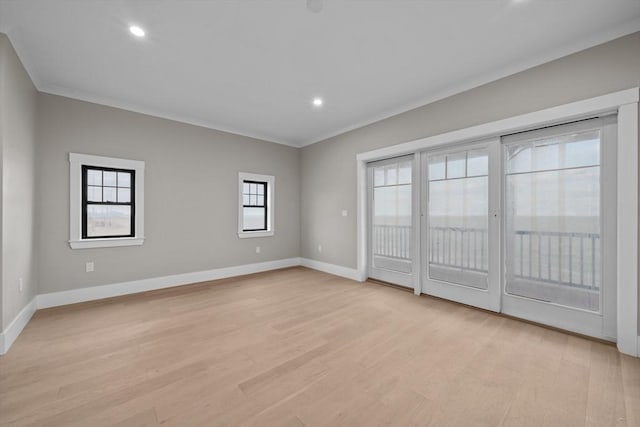 empty room featuring light hardwood / wood-style floors and ornamental molding