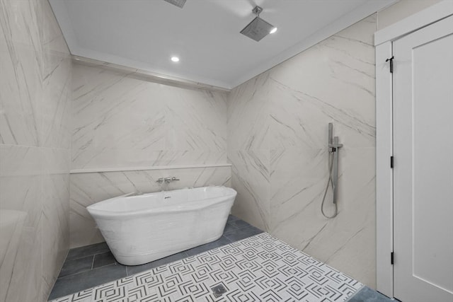 bathroom with a washtub and tile walls