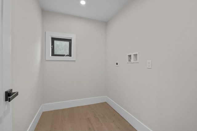 clothes washing area featuring hardwood / wood-style flooring, electric dryer hookup, and washer hookup