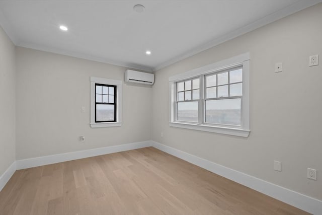 unfurnished room with crown molding, light hardwood / wood-style floors, and a wall mounted air conditioner