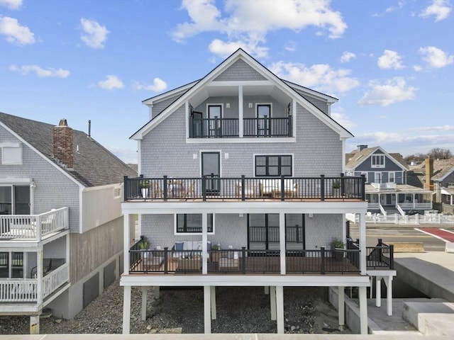 back of property featuring a balcony