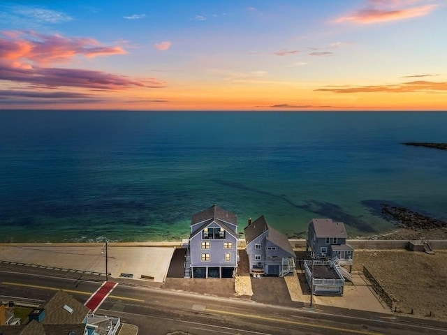 aerial view at dusk with a water view