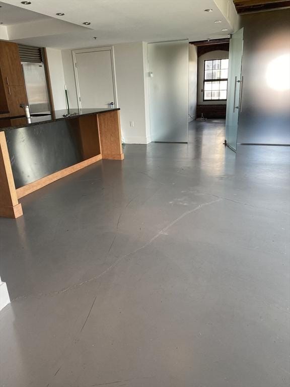 unfurnished room with finished concrete flooring