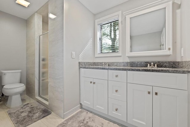 bathroom featuring a sink, toilet, double vanity, and a shower stall