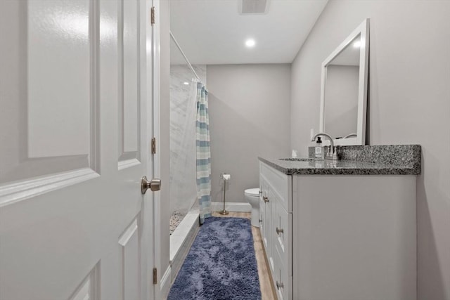 full bath featuring vanity, baseboards, visible vents, a shower stall, and toilet