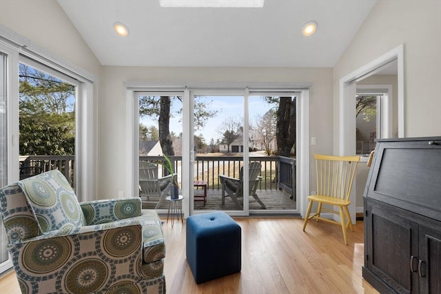 living area with vaulted ceiling, light wood-style flooring, recessed lighting, and baseboards