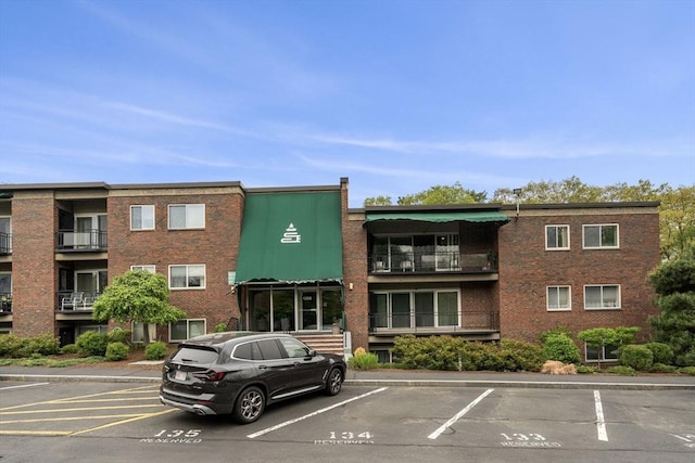 view of building exterior with uncovered parking