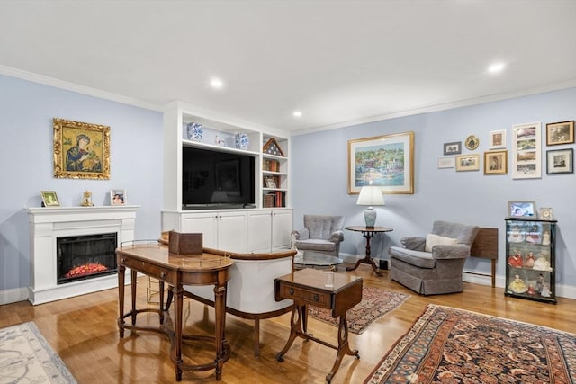 living room with crown molding, light wood finished floors, a glass covered fireplace, recessed lighting, and baseboards