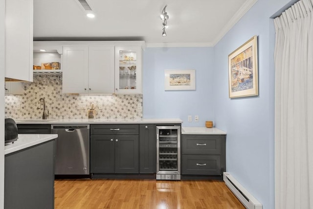 indoor wet bar featuring stainless steel dishwasher, wine cooler, a baseboard heating unit, light wood-type flooring, and decorative backsplash