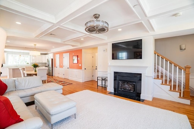 41 Washington Unit C, Newburyport, MA 01950 - living area with coffered ceiling, light wood-style flooring, stairs, beam ceiling, and ornamental molding