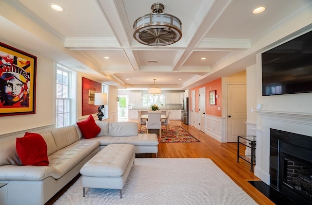 41 Washington Unit C, Newburyport, MA 01950 - living area with light wood finished floors, coffered ceiling, ornamental molding, beamed ceiling, and a fireplace with flush hearth