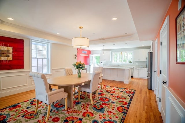 41 Washington Unit C, Newburyport, MA 01950 - dining space with light wood-style floors, a tray ceiling, crown molding, wainscoting, and recessed lighting