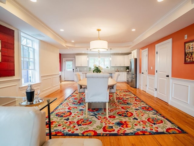 41 Washington Unit C, Newburyport, MA 01950 - dining area with light wood-type flooring, a tray ceiling, a decorative wall, recessed lighting, and wainscoting