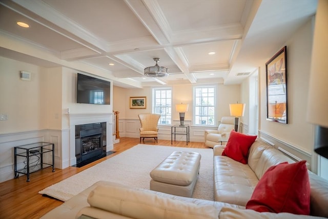 41 Washington Unit C, Newburyport, MA 01950 - living room featuring wood finished floors, beamed ceiling, a fireplace with flush hearth, coffered ceiling, and crown molding