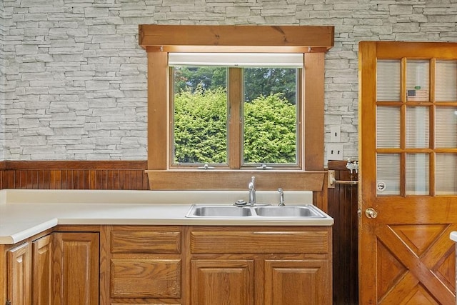 128 Arthur Ave, Athol, MA 01331 - kitchen featuring a sink, light countertops, and brown cabinetry