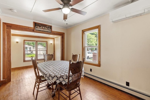 128 Arthur Ave, Athol, MA 01331 - dining room with a wall mounted AC, a baseboard heating unit, light wood finished floors, healthy amount of natural light, and ornamental molding