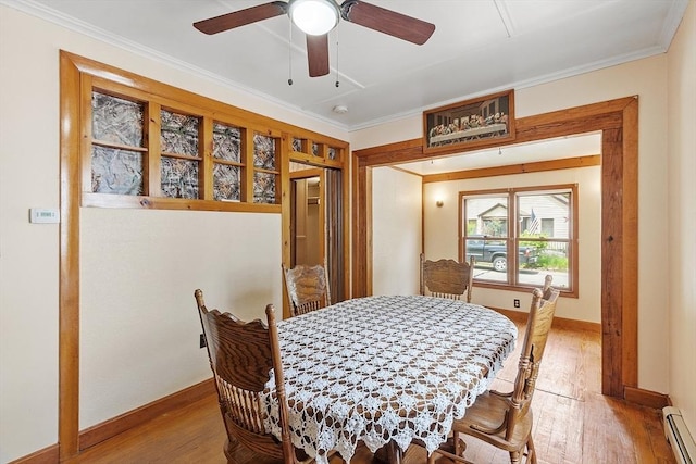 128 Arthur Ave, Athol, MA 01331 - dining space featuring baseboard heating, light wood-style flooring, ceiling fan, baseboards, and crown molding