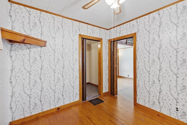 128 Arthur Ave, Athol, MA 01331 - empty room featuring crown molding, wallpapered walls, wood finished floors, a ceiling fan, and baseboards