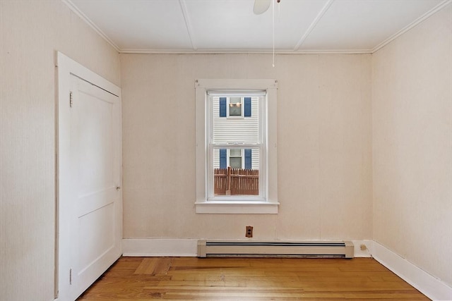 128 Arthur Ave, Athol, MA 01331 - empty room featuring baseboard heating, wood finished floors, attic access, crown molding, and baseboards