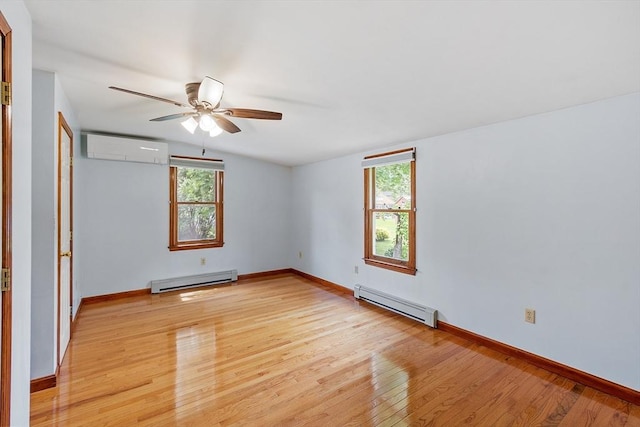 128 Arthur Ave, Athol, MA 01331 - spare room with baseboard heating, a wall mounted air conditioner, a baseboard heating unit, light wood-type flooring, and a ceiling fan